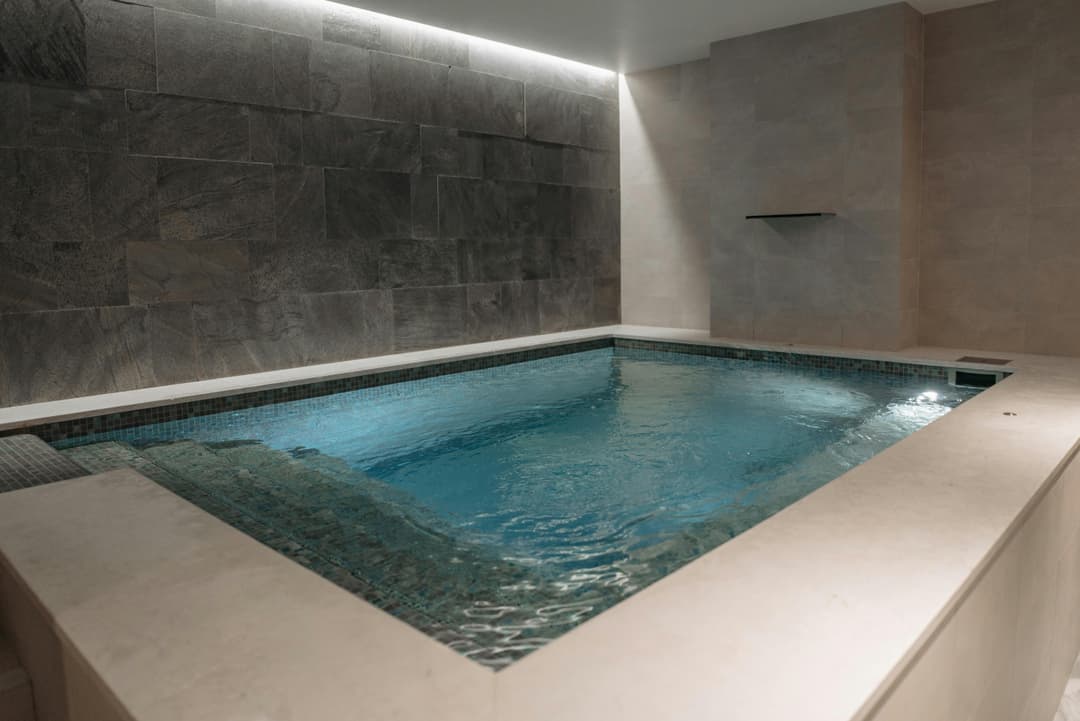 Pool and Spa. A modern indoor swimming pool with recessed lighting.